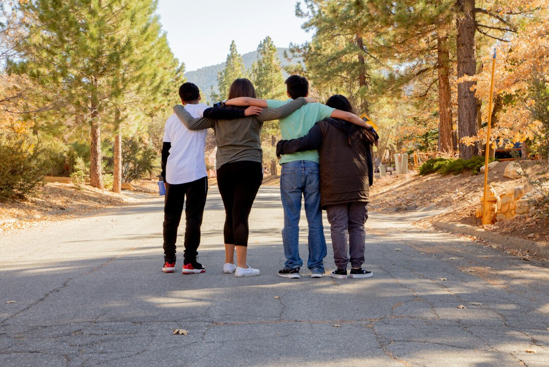 Group of four diverse professional facilitators standing together
